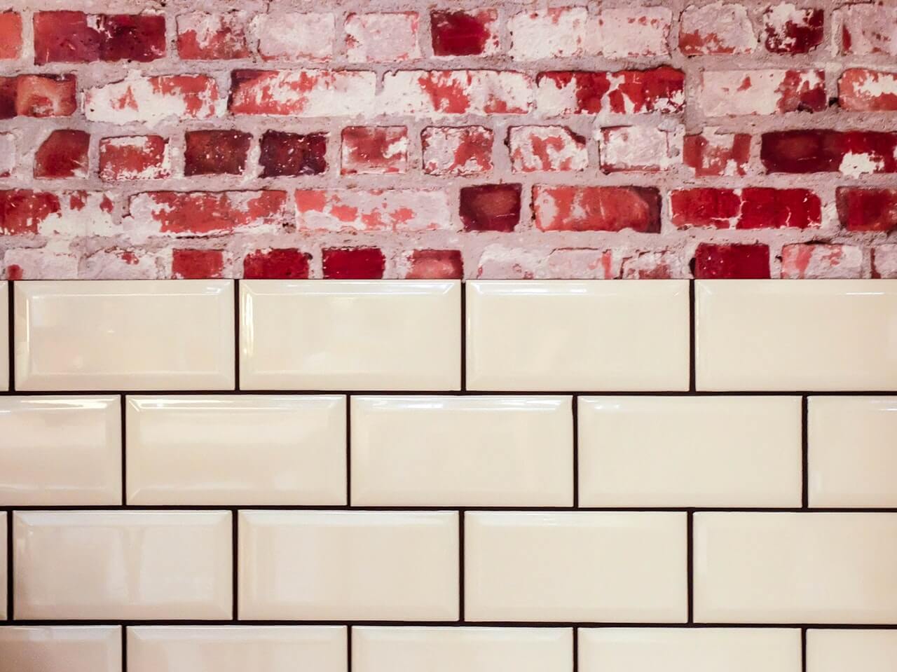 White ceramic wall beside red concrete bricks