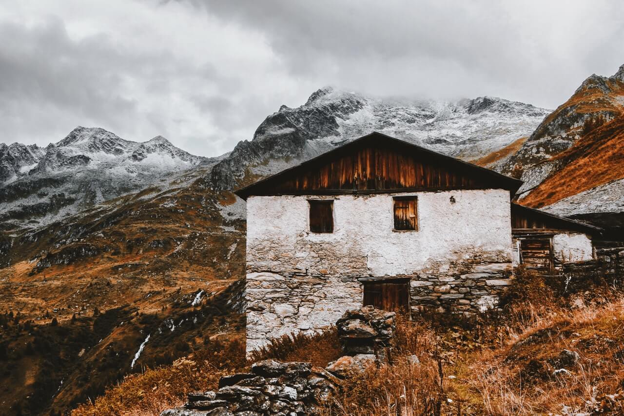 House near snow capped mountains